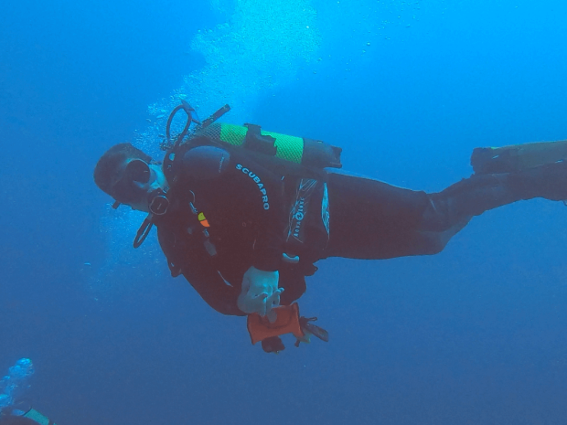 Scuba diver influencer Joe Bilbow diving and posing for the photo