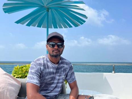 Siraj Ahmed sitting at the beach 