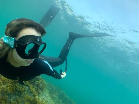 PADI AmbassaDiver Kayleigh Slowey scuba diving underwater.