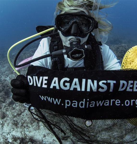 Diver holding marine debris bag