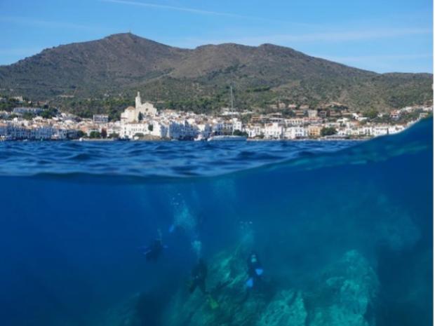 Photo from the sea with a town off in the distance.