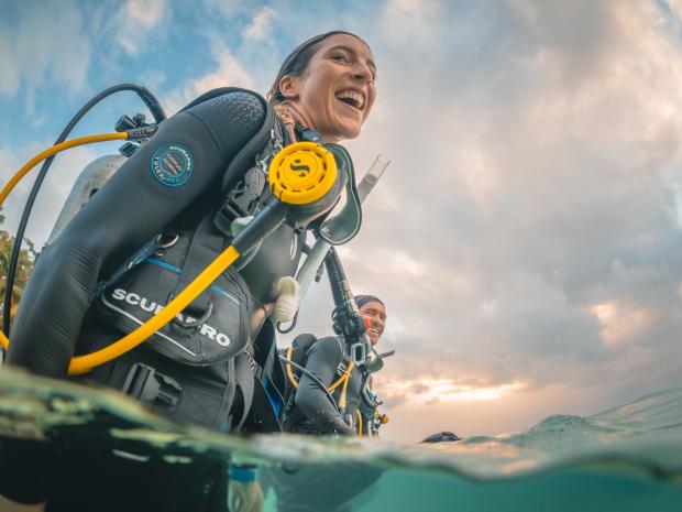 Two divers smiling after a dive