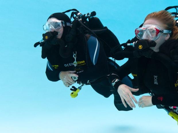 Divers with rebreathers in a pool