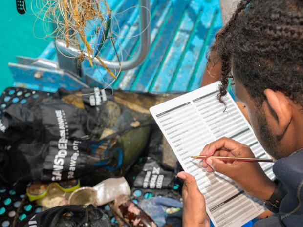 Diver recording collected debris on a Dive Against Debris data card