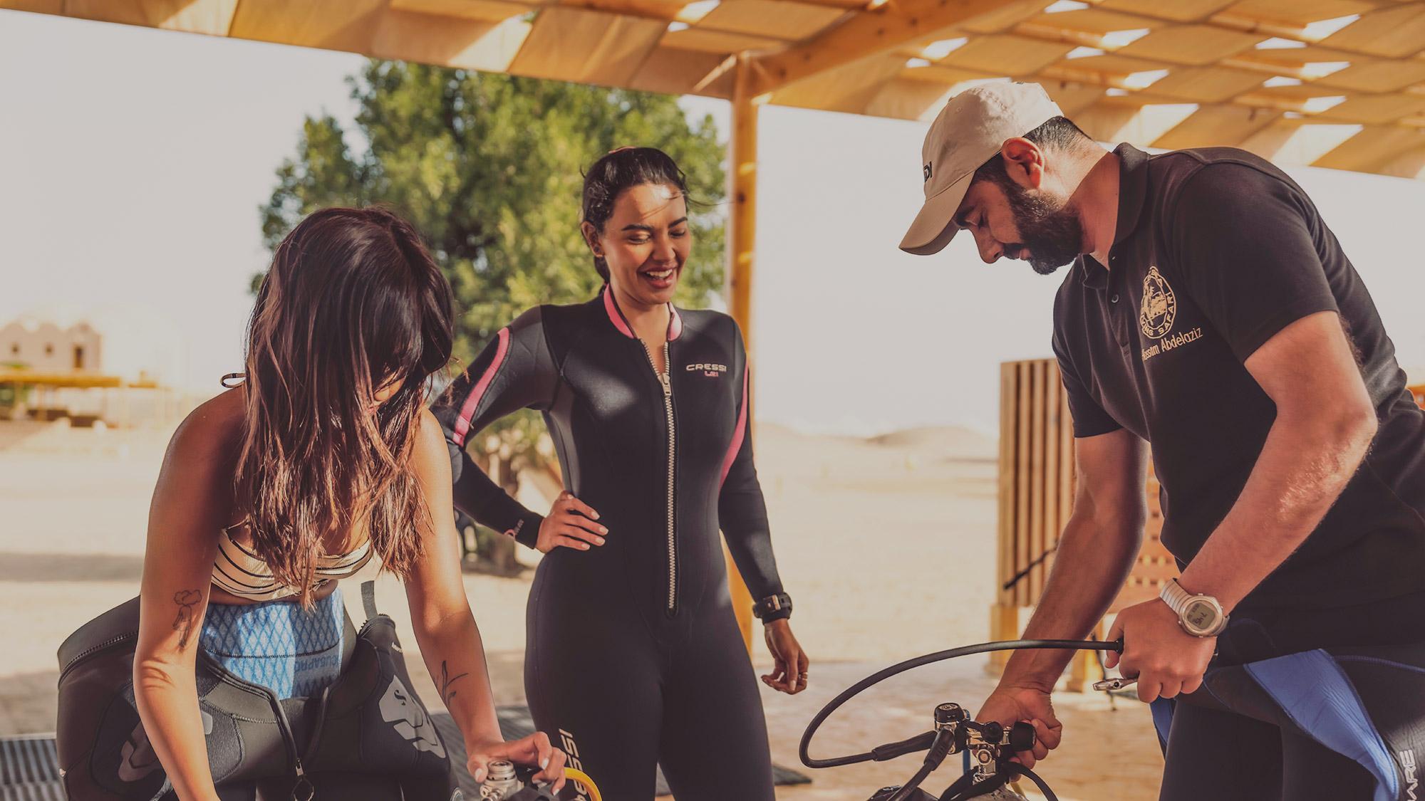 Scuba diving instructor and divers with scuba gear