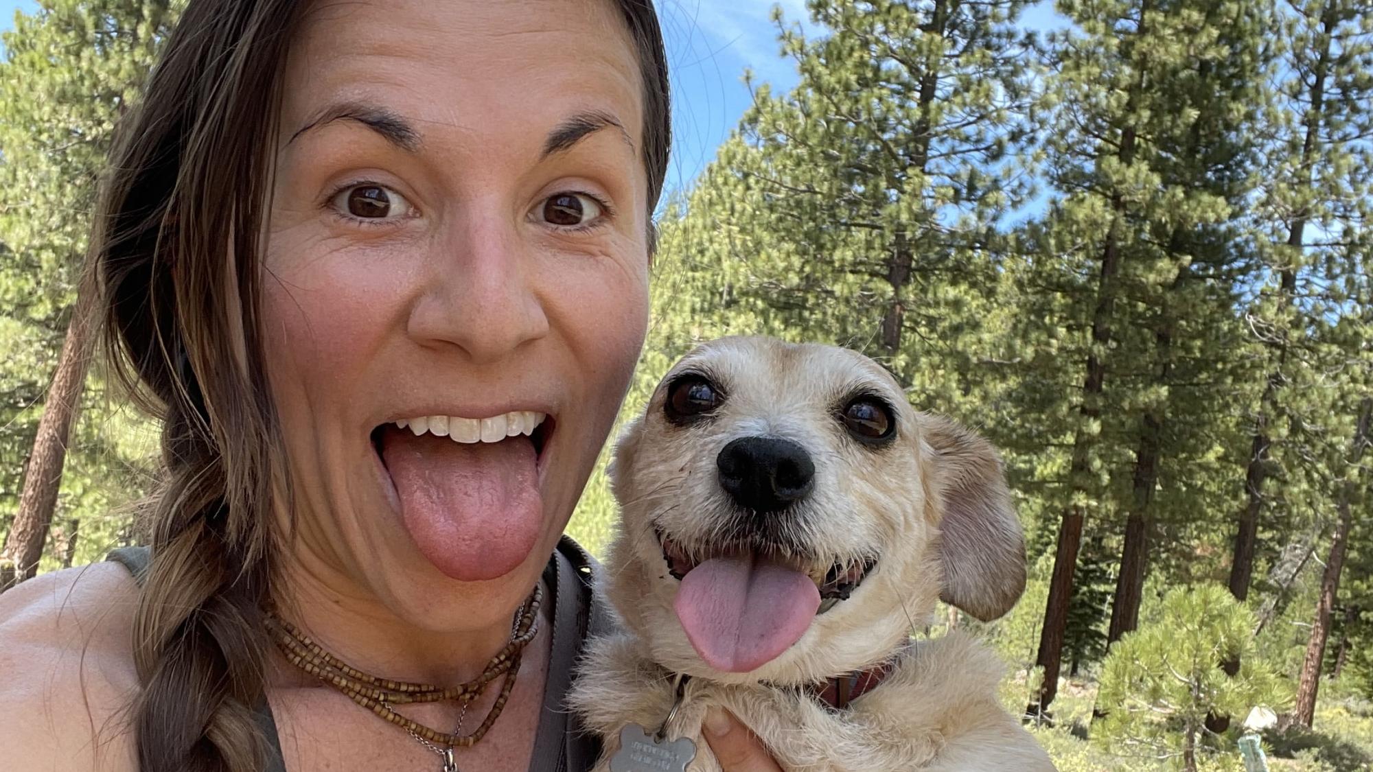 Sarah Miller and her dog taking a photo while hiking.