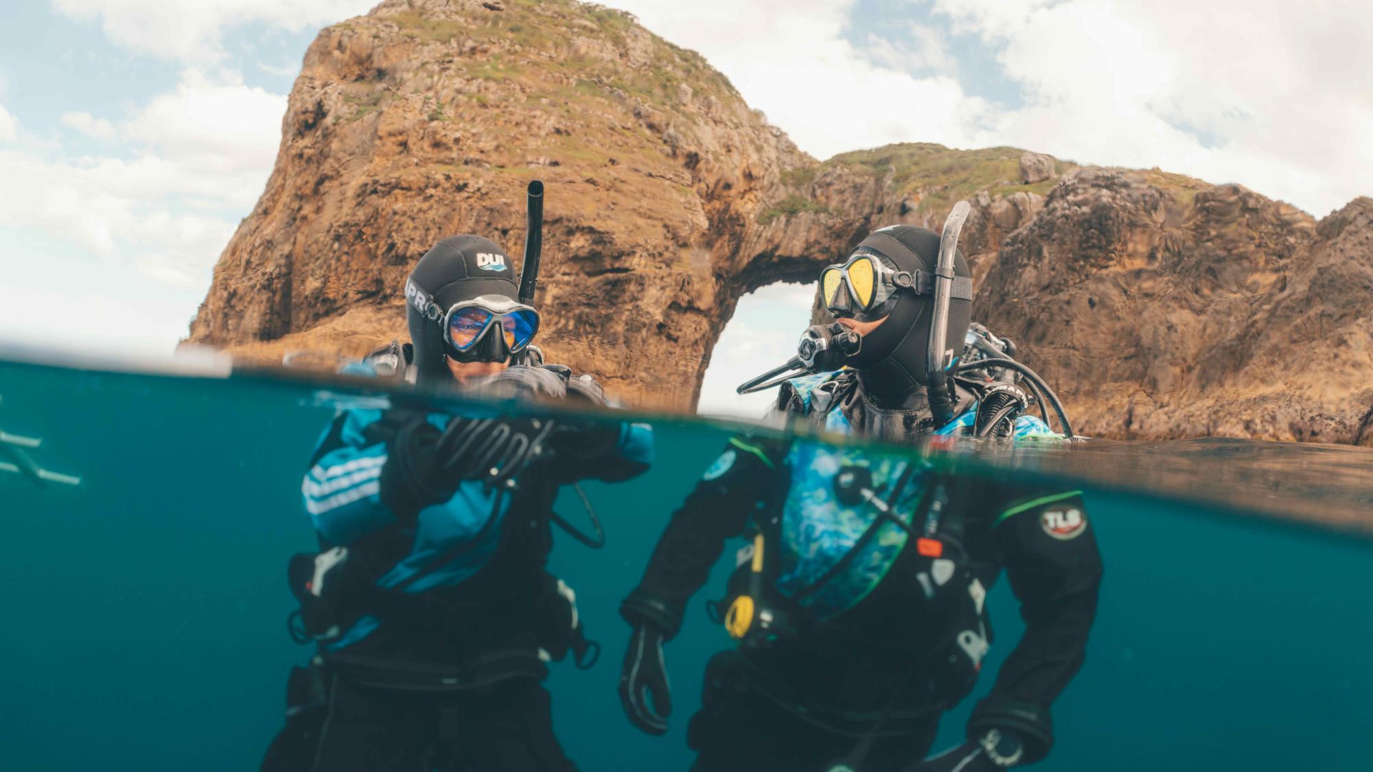 Divers talking at the surface of the ocean