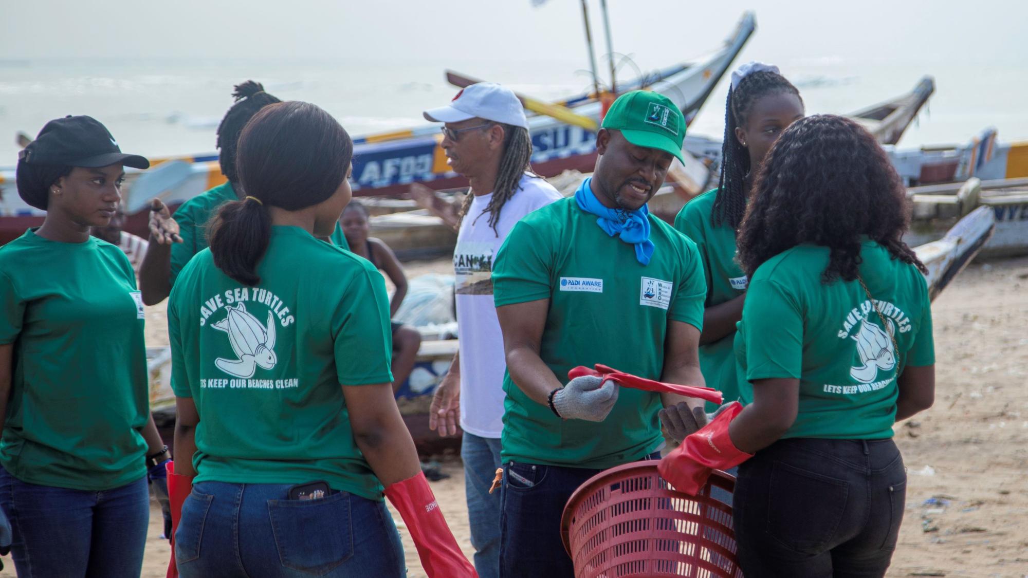 WHRO Beach Cleanup_ Andrews Agyekumhene (green cap) explaining the process before the exercise.